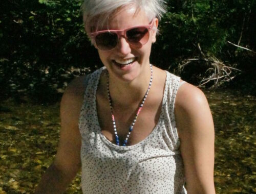 A woman wearing sunglasses posing for the camera