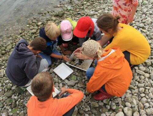 A group of people sitting on a rock